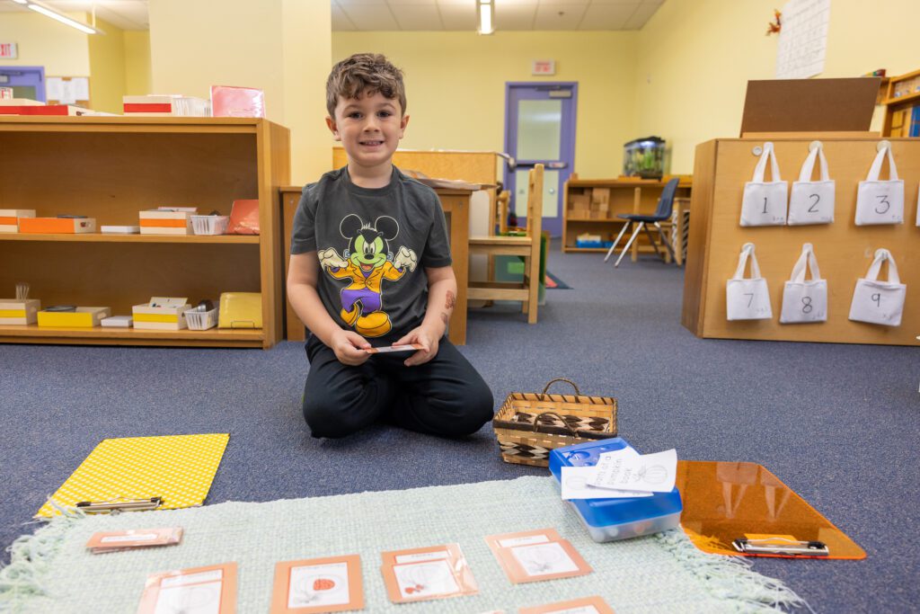 boy sitting on floor with activity