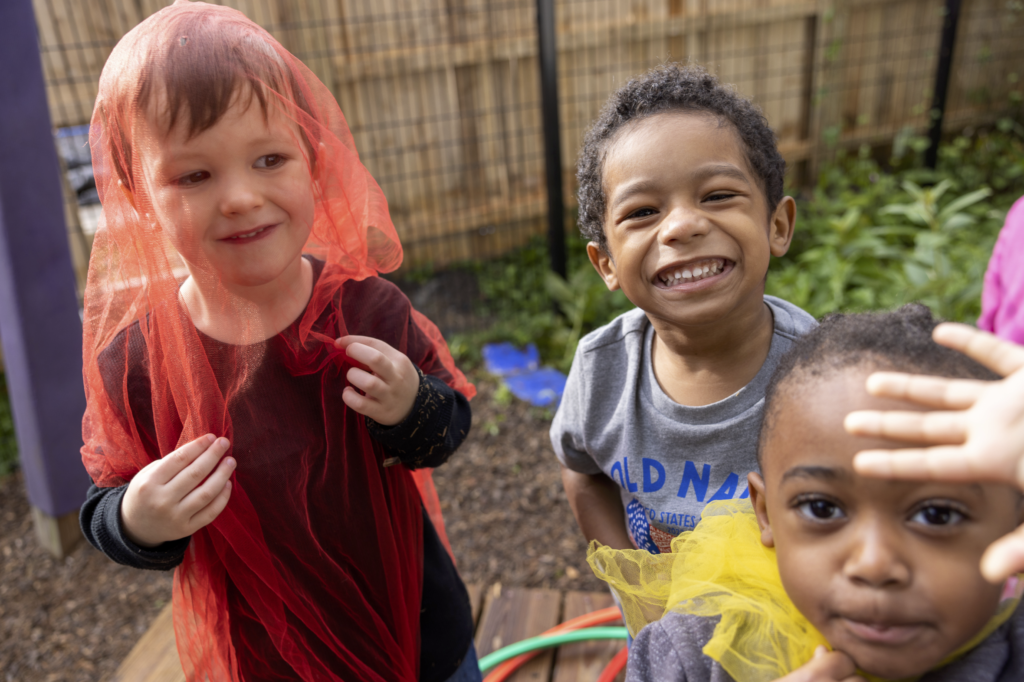 three boys being silly n the playground at grace montessori school