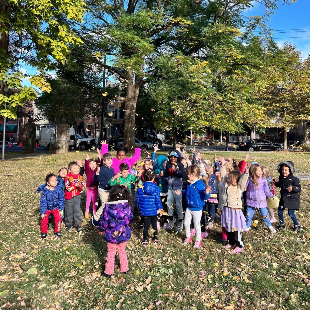 students playing outside in the leaves